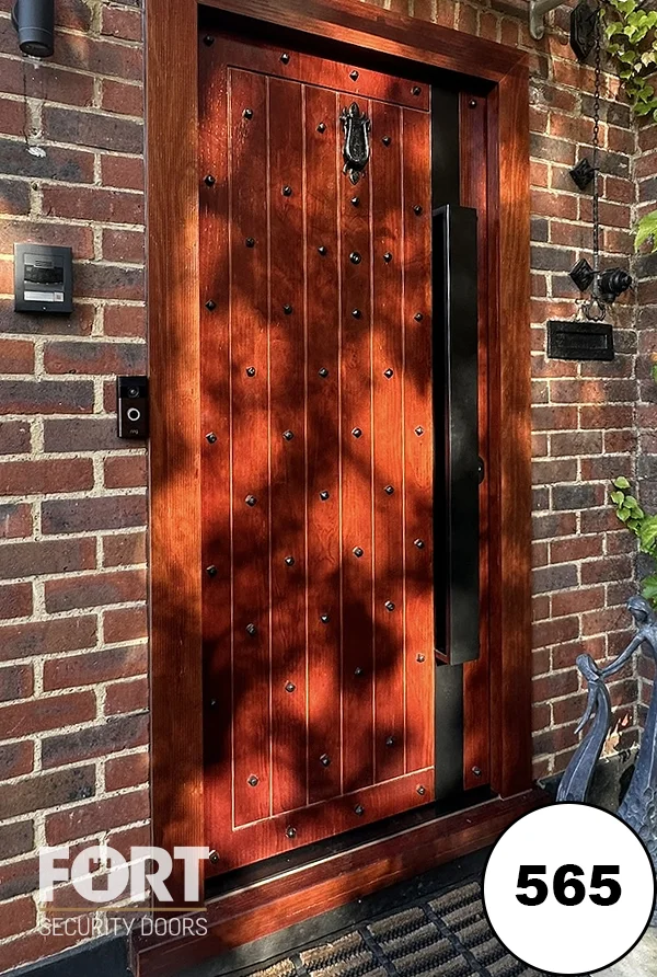 0565 Rustic Oak Stain Security Door With Studded Detail And Black Iron Ironmongery